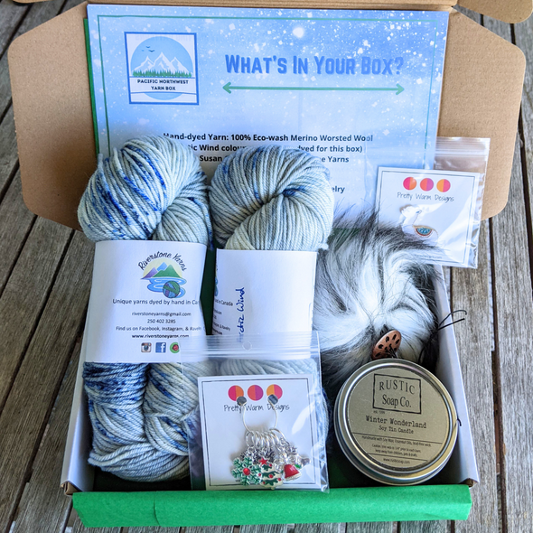 Christmas Yarn Box with 2 skeins of yarn, stitch markers for knitting or crochet, Winter Wonderland soy candle, faux fur pompom, and Llama enamel pin