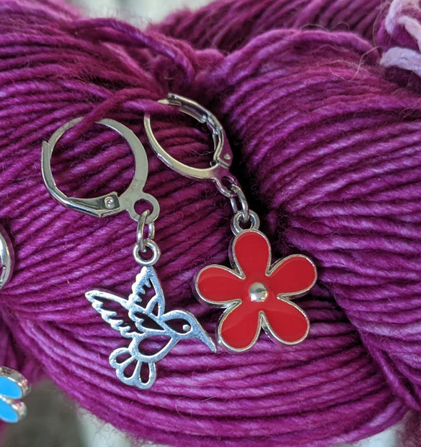 Hummingbird and Red Flower Locking Stitch Markers for Crocheting or Knitting shown on yarn skein