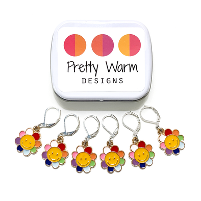 Set of six yellow and rainbow petal enamel happy face flower charms locking stitch markers for crochet with decorative tin with logo by Pretty Warm Designs