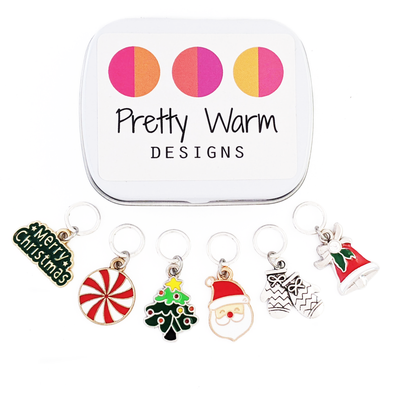 Set of 6 metal alloy and enamel Christmas stitch markers with storage tin, ring style for knitting. Includes "Merry Christmas", peppermint, Christmas tree, Santa, Mittens, and Bell