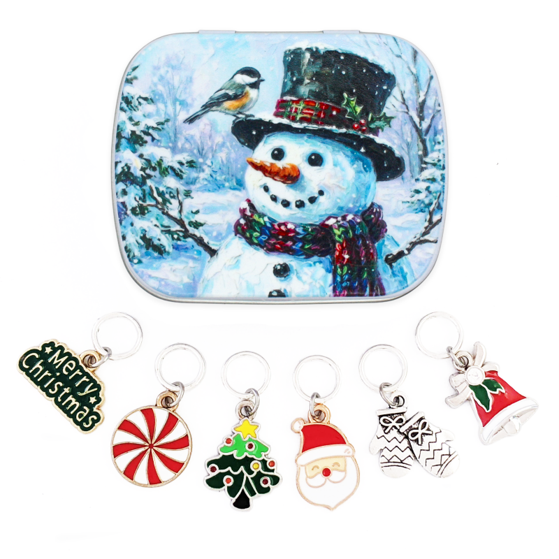 Six Christmas stitch markers on closed rings with a snowman and chickadee keepsake tin