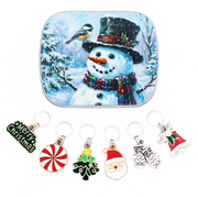 Six Christmas stitch markers on closed rings with a snowman and chickadee keepsake tin