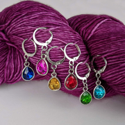 Crystal Jewels set of 6 gem coloured stitch holders with storage tin by Pretty Warm Designs shown on worsted weight yarn