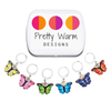 Set of six enamel butterfly charm crochet locking stitch markers in red, yellow, green, blue, pink and purple with storage tin for crochet by Pretty Warm Designs