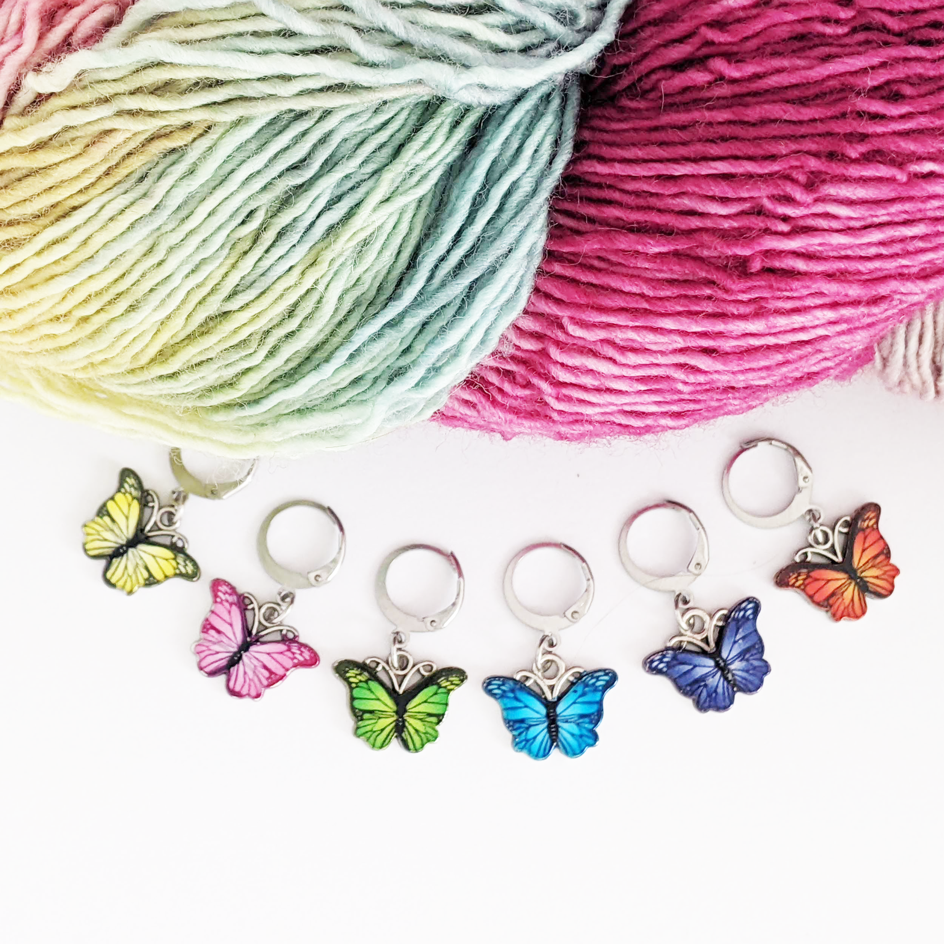 Set of six enamel butterfly charm crochet locking stitch markers in red, yellow, green, blue, pink and purple for crochet by Pretty Warm Designs