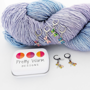 Dragonfly Locking Stitch Markers set of 6 with storage tin, shown with lavender yarn, by Pretty Warm Designs