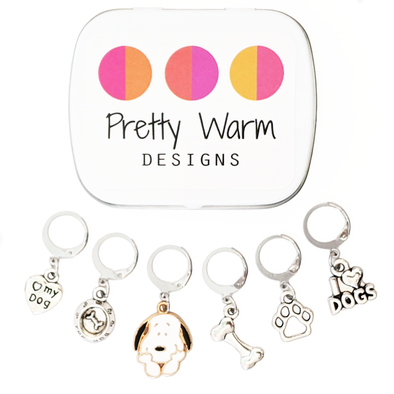 Set of 6 pet dog themed locking stitch markers for crochet. Includes a love my dog heart, a bowl with a bone, a black and white beagle, a bone, a paw, and an I love dogs sign. Storage tin included.