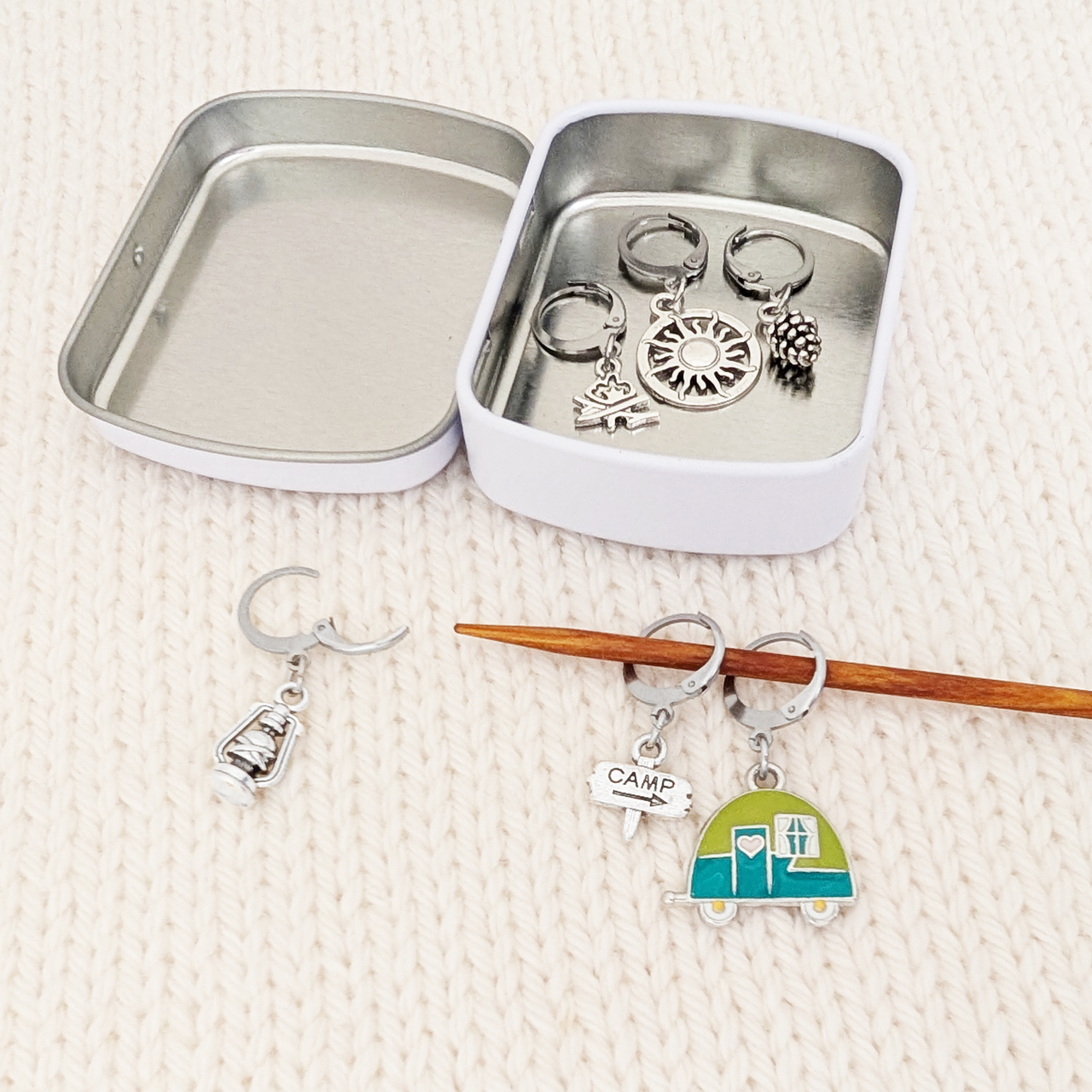Go Camping Crochet Stitch Markers, Set of 6 with tin, shown on a knitting needle