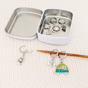 Go Camping Crochet Stitch Markers, Set of 6 with tin, shown on a knitting needle