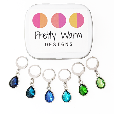 Ocean Waters locking stitch marker set of 6 with storage tin. Removable lever-back clasps for crochet or knitting.