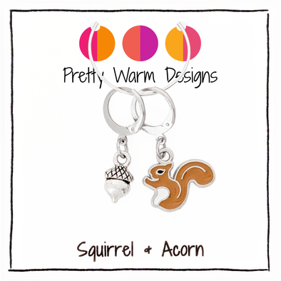A brown enamel squirrel and silver acorn charm locking stitch marker duo, shown on a Pretty Warm Designs product card.