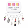 Wine Lover Stitch Marker Set with Storage Tin, includes six crochet locking stitch holders and decorative tin with Pretty Warm Designs logo.