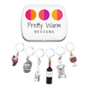 Wine Lover Stitch Marker Set with Storage Tin, includes six crochet locking stitch holders and decorative tin with Pretty Warm Designs logo.