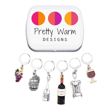 Wine Lover Stitch Marker Set with Storage Tin, includes six crochet locking stitch holders and decorative tin with Pretty Warm Designs logo.