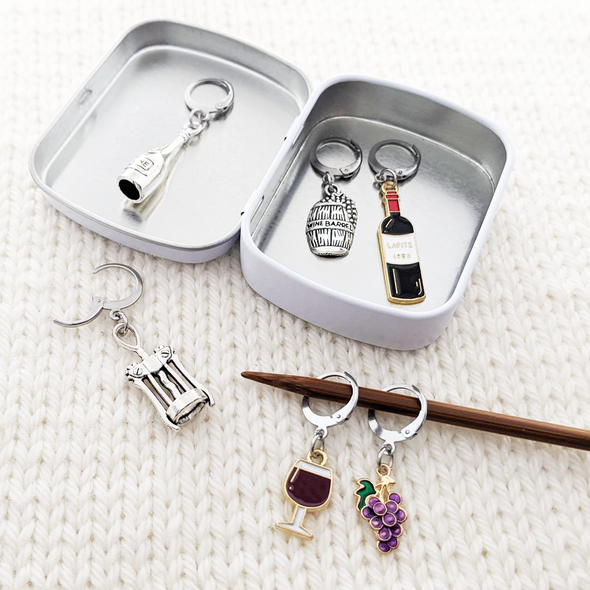 Wine Lover Stitch Marker Set with Storage Tin, includes six crochet locking stitch holders and decorative tin with Pretty Warm Designs logo.