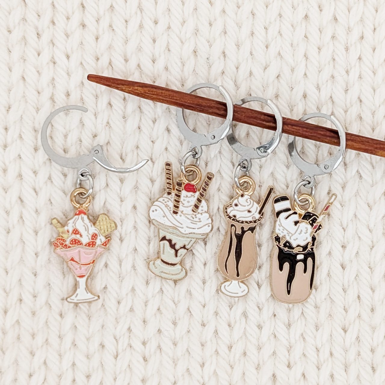 Set of 4 Ice Cream Sundae Locking Stitch Markers for crochet or knitting by Pretty Warm Designs, shown on a knitting needle with an open clasp