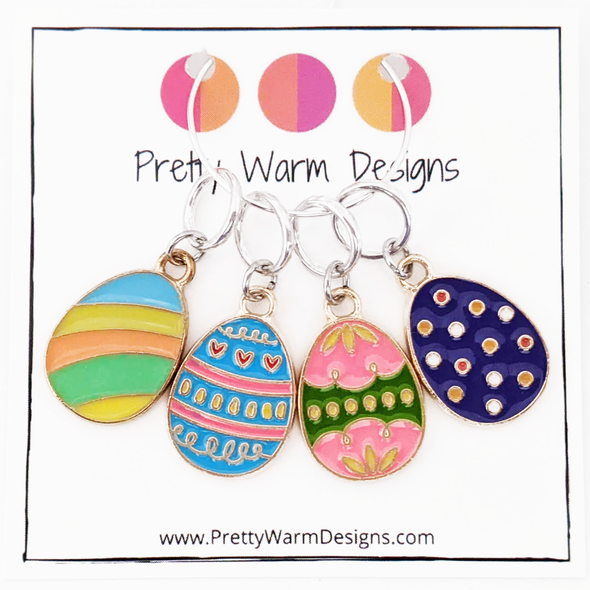 Set of 4 Easter egg themed ring stitch markers for knitting shown on Pretty Warm Designs cardstock