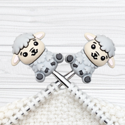 London Fog Feeling Sheepish sheep stitch stoppers on crossed knitting needles showing light grey colouring