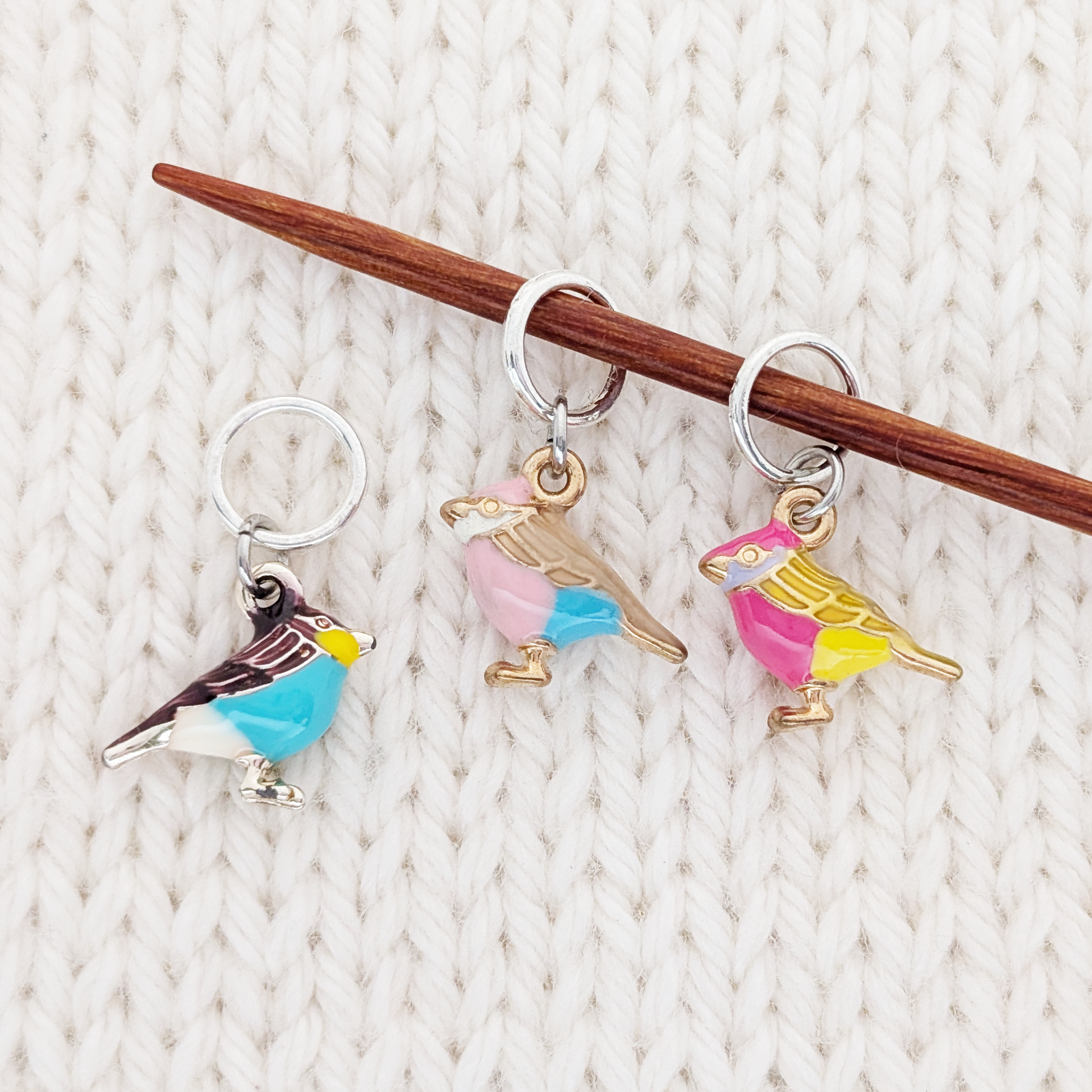 A Bird In the Hand Stitch Markers for knitting - Set of three ring style 3D bird charm stitch markers, shown on knitting needle