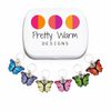 Set of 6 multicolored butterfly ring stitch markers for knitting with decorative storage tin by Pretty Warm Designs