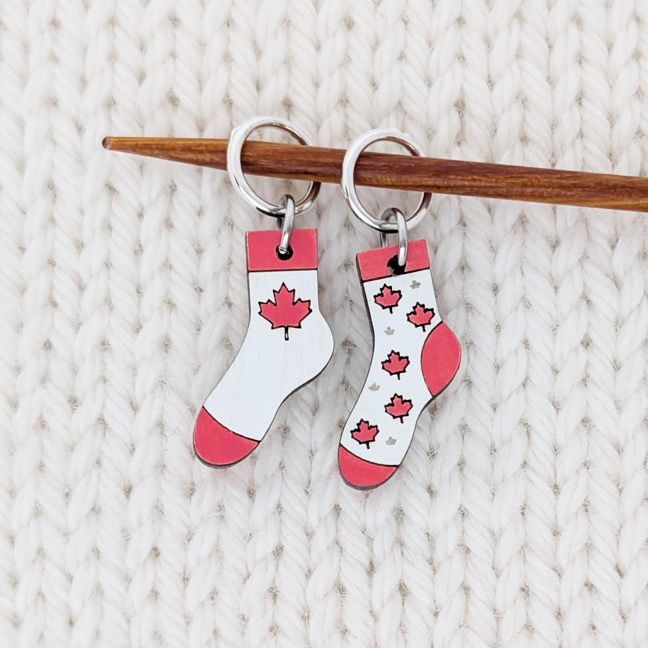 Canada Flag Sock Stitch Markers for Knitting - Ring Style, shown on knitting needle.