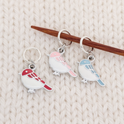 Set of 3 Birds of a Feather Stitch markers for knitting, ring style with red, blue, and pink bird charms, shown on a knitting needle