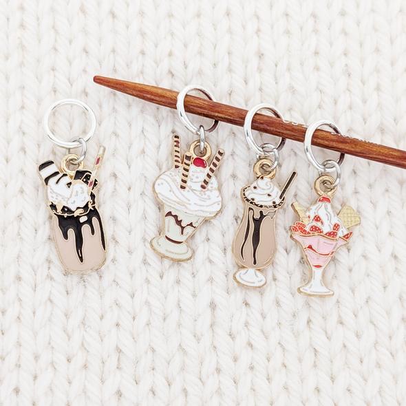 Set of 4 Ice Cream Treats Stitch Markers for Knitting. Enamel and Metal Charms attached to Closed Rings by Pretty Warm Designs, shown with Knitting Needle