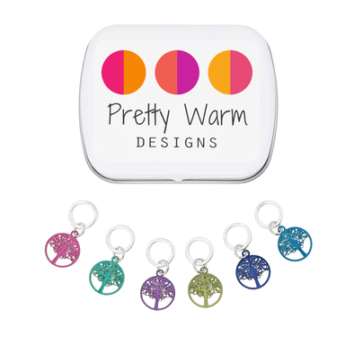 Six colour coated stainless steel round tree of life charm snag free ring stitch markers for knitting and decorative storage tin with Pretty Warm Designs logo by Pretty Warm Designs Inc