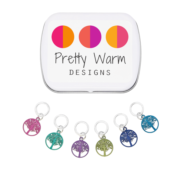 Six colour coated stainless steel round tree of life charm snag free ring stitch markers for knitting and decorative storage tin with Pretty Warm Designs logo by Pretty Warm Designs Inc
