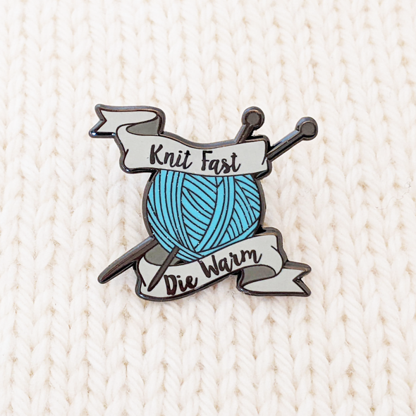 Knit Fast Die Warm sign with blue yarn ball and 2 knitting needles - enamel pin for project bags