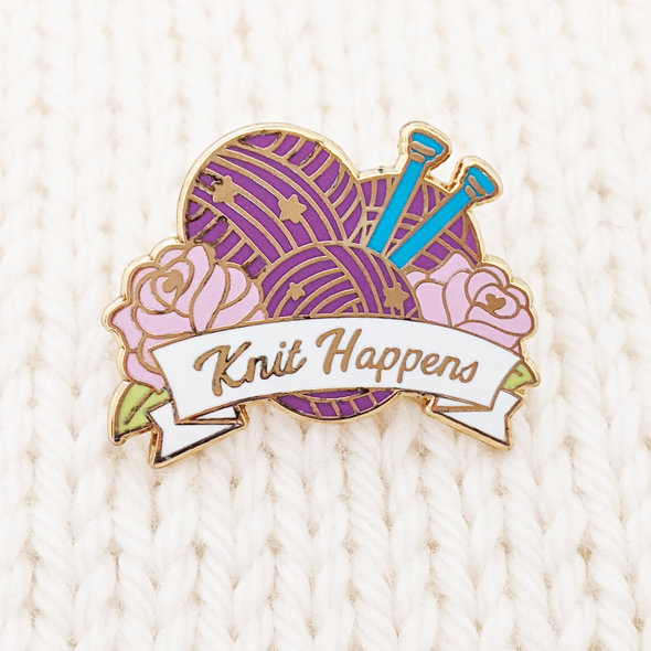 Knit Happens enamel pin for project bags - sign with 2 roses, 3 balls of purple yarn, two blue knitting needles