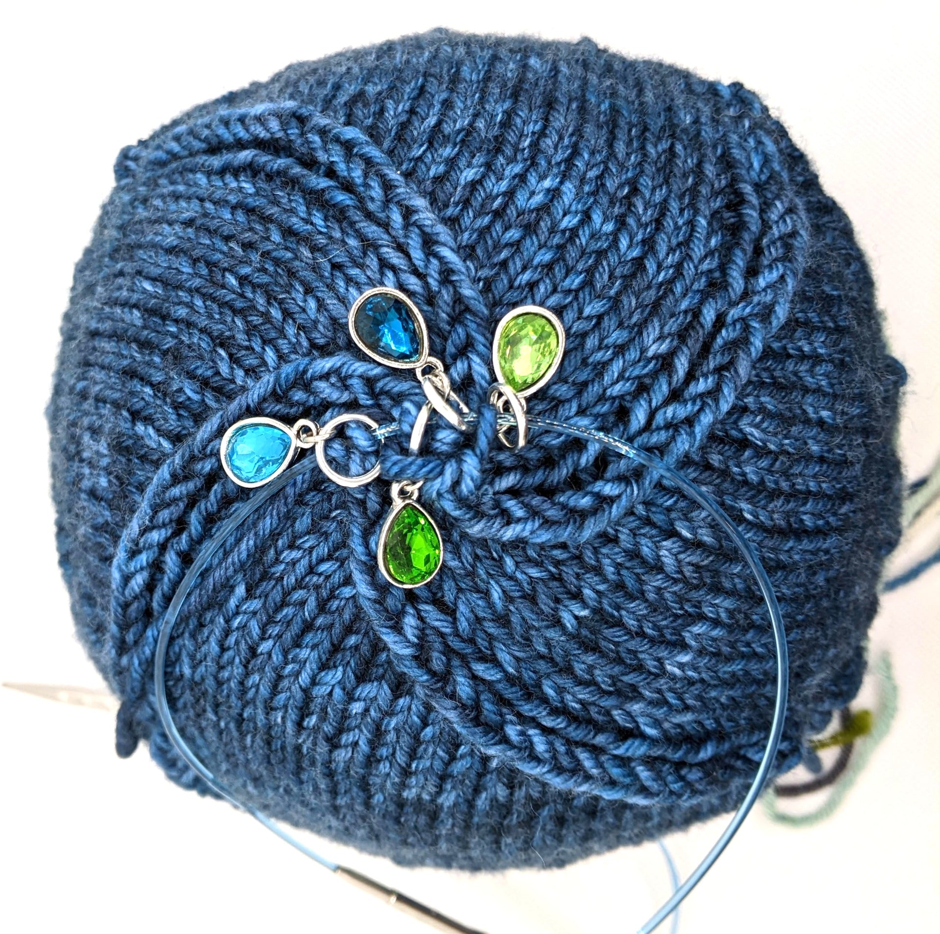 Ocean Waters stitch markers shown as decrease markers on a toque knitting project by Pretty Warm Designs