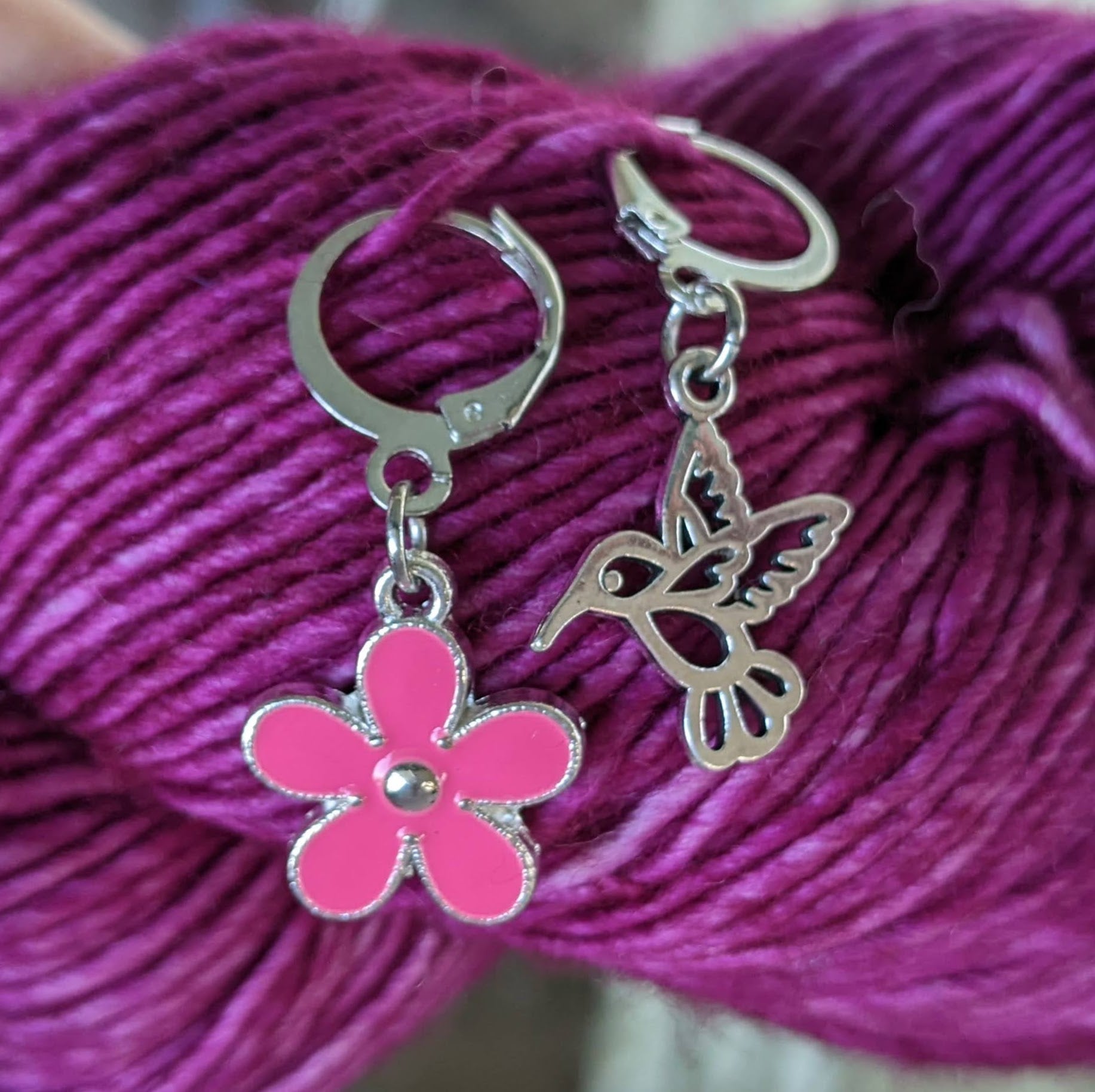 Hummingbird and Red Flower Locking Stitch Markers for Crocheting or Knitting shown on yarn skein