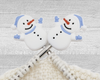 two Christmas Snowman stitch stoppers for knitting with blue hat, scarf, and mittens