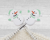 two Christmas Snowman stitch stoppers for knitting with green hat, scarf, and mittens