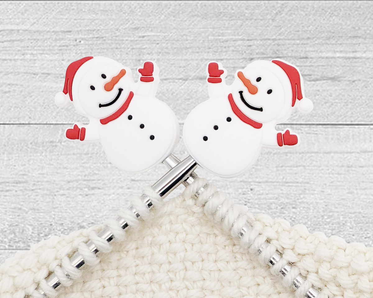 two Christmas Snowman stitch stoppers for knitting with red hat, scarf, and mittens