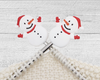 two Christmas Snowman stitch stoppers for knitting with red hat, scarf, and mittens