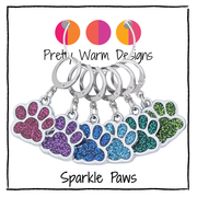 Pretty Warm Designs Sparkle Paws locking stitch markers, a full set of six, for knitting and crochet. The vibrant, glitter enamel paw print charms, in a color gradient from hot pink to bright green, are attached to 316 stainless steel leverback locking clasps.