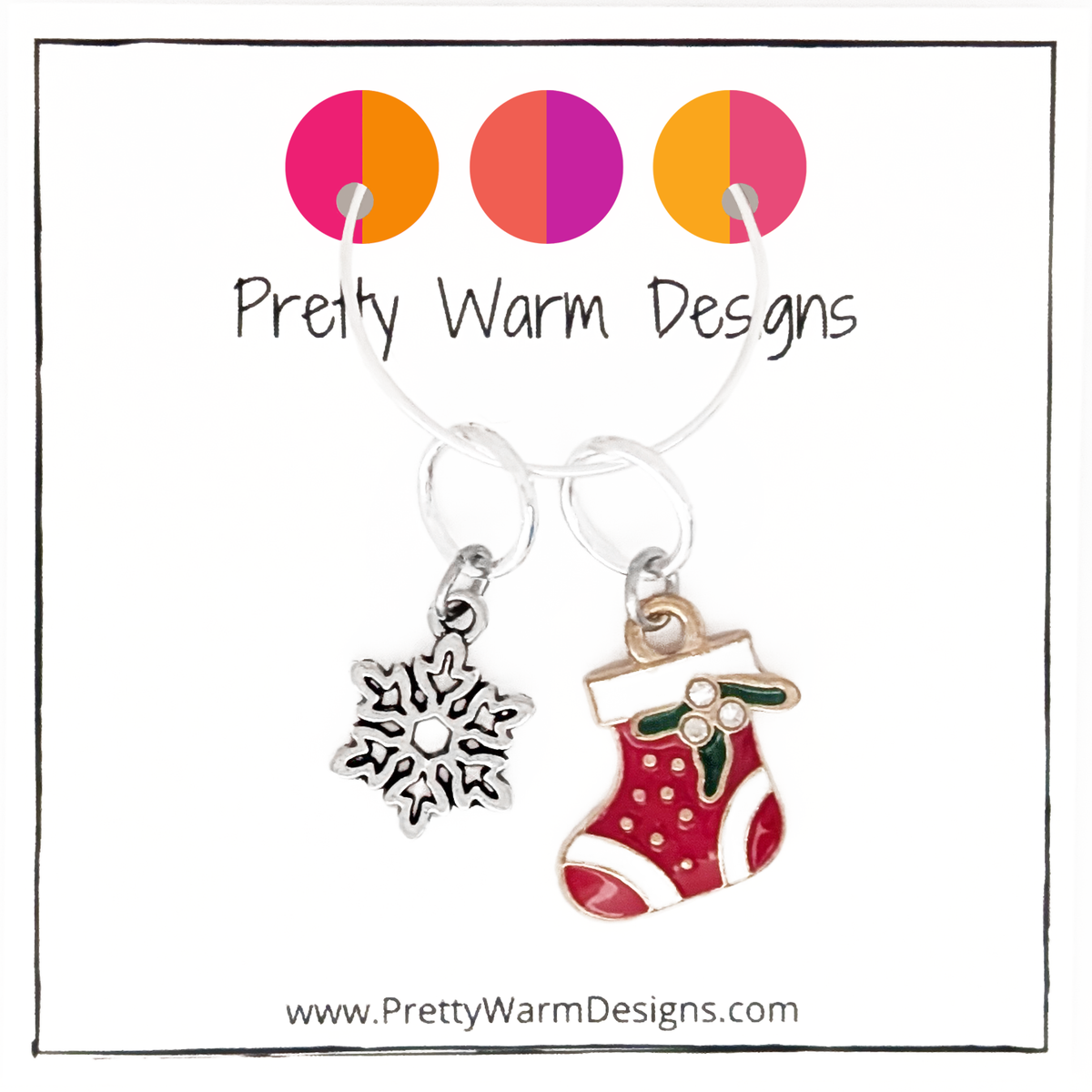 One red, white and green enamel with rhinestones Christmas stocking ring stitch marker and one silver alloy snowflake ring stitch marker for knitting with Pretty Warm Designs text and logo