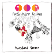 Set of six stitch markers for knitting, including a red enamel toadstool, as well as an antique silver acorn, toadstool, woodland gnome, pine cone and Christmas tree sold by Pretty Warm Designs Inc.
