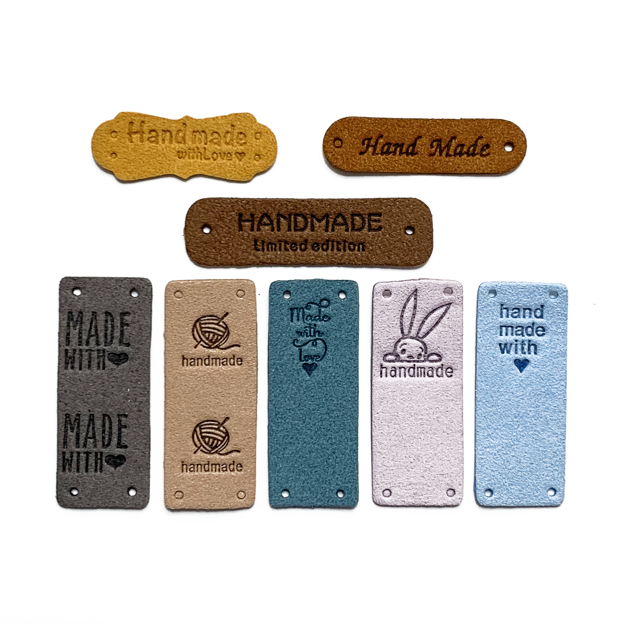Eight assorted colours and designs of PU vegan polyurethane leather garment label tags for knitted and crocheted projects sold by Pretty Warm Designs Inc.