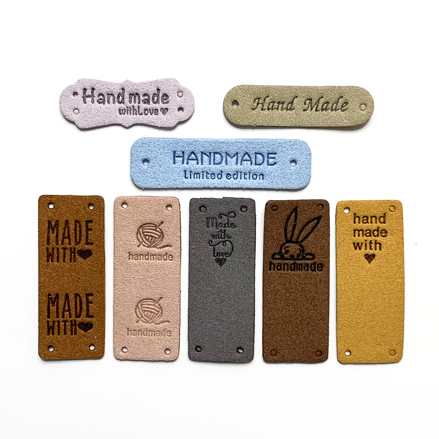 Eight assorted colours and designs of PU vegan polyurethane leather garment label tags for knitted and crocheted projects sold by Pretty Warm Designs Inc.