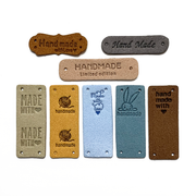 Eight assorted colours and designs of PU vegan polyurethane leather garment label tags for knitted and crocheted projects sold by Pretty Warm Designs Inc.