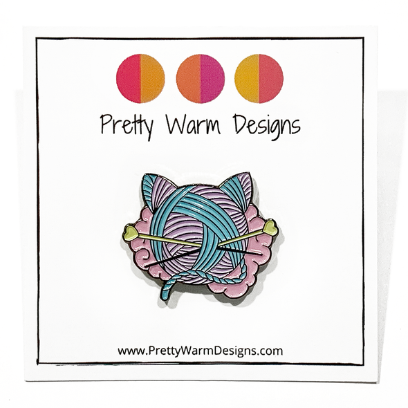Pink, turquoise and yellow enamel on black background cat shaped yarn knitting pin by Pretty Warm Designs