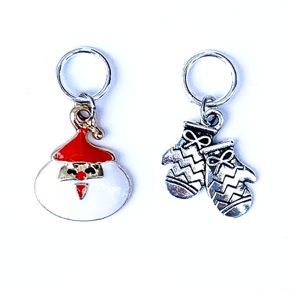 Two Christmas-themed knitting ring stitch markers, one red and white Santa and one silver toned mittens by Pretty Warm Designs