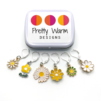 Set of six white, yellow and green enamel daisy charms with silver plated lever back clasps stitch markers for crochet with decorative tin with logo by Pretty Warm Designs