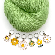 Set of six white, yellow and green enamel daisy charms snag free ring stitch markers with green yarn for knitting by Pretty Warm Designs