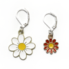 Two enamel charm crochet locking stitch markers with one white and one red daisy by Pretty Warm Designs