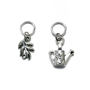 One antiqued silver leaf branch and one antiqued silver watering can snag free ring stitch markers for knitting by Pretty Warm Designs Inc