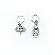 Two antiqued silver stitch markers, one camping sign and one lantern for knitting by Pretty Warm Designs